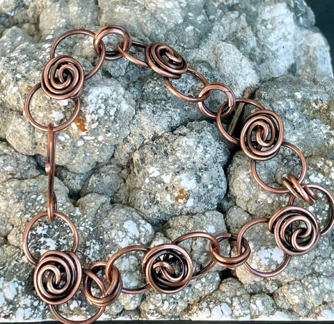 This Copper Flower Bud Bracelet is ideal for individuals who appreciate handcrafted jewelry with a touch of nature-inspired design. It appeals to those who love elegant, feminine accessories and value artisanal craftsmanship. This bracelet is perfect for those looking for a unique piece that can be worn daily or on special occasions.