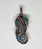 This Carved Labradorite Sea Horse Pendant in Copper is a stunning and meaningful accessory that combines natural beauty with artisan craftsmanship. With its intricate wire wrapping and the mesmerizing, iridescent qualities of labradorite, this pendant offers a unique and mystical appeal. Whether worn as a statement piece or cherished for its symbolic significance, this pendant is a beautiful addition to any jewelry collection, particularly for those who appreciate the ocean and spiritual connections.