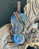 This Carved Labradorite Sea Horse Pendant in Copper is a stunning and meaningful accessory that combines natural beauty with artisan craftsmanship. With its intricate wire wrapping and the mesmerizing, iridescent qualities of labradorite, this pendant offers a unique and mystical appeal. Whether worn as a statement piece or cherished for its symbolic significance, this pendant is a beautiful addition to any jewelry collection, particularly for those who appreciate the ocean and spiritual connections.