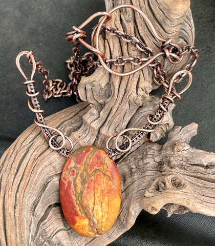 This vibrant necklace features stunning Picasso Jasper stone, known for their unique and colorful patterns that resemble abstract art. The rich earthy tones of the Jasper are perfectly complemented by the warm glow of hand-formed copper accents, creating a harmonious and eye-catching design. Ideal for those who appreciate nature-inspired, bold jewelry, this necklace is a statement piece that adds color and character to any outfit.