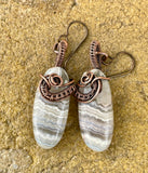 These Hypoallergenic Wire Wrapped Copper and Laguna Lace Agate Earrings feature elegant Laguna Lace Agate stones delicately wrapped in hypoallergenic copper wire. Known for their distinctive patterns and soothing colors, Laguna Lace Agate stones are beautifully showcased in these earrings, while the copper setting provides a warm and sophisticated touch. Designed with sensitivity in mind, these earrings offer both style and comfort for those with metal allergies.