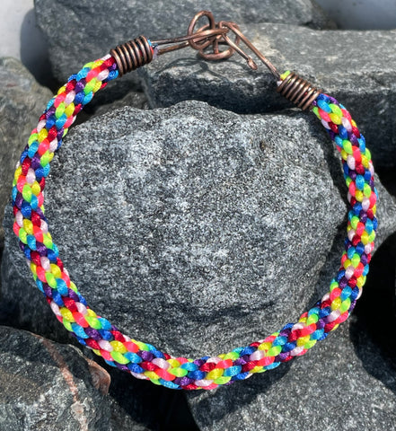 This Adjustable Colorful Satin Nylon Kumihimo Bracelet features a vibrant and stylish design created using the traditional Japanese kumihimo braiding technique. Made with colorful satin nylon cords, this bracelet is not only visually striking but also offers versatility with its adjustable fit.