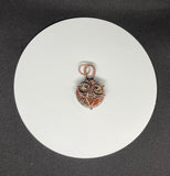 This unique pendant features a beautifully patterned Leopard Skin Jasper stone, nestled within a hand-sculpted copper owl design. The earthy tones and intricate patterns of the Jasper mirror the natural beauty of the wise owl, symbolizing wisdom and intuition. The copper detailing enhances the organic feel of the piece, making it a charming and meaningful accessory for nature lovers or those drawn to mystical symbolism.