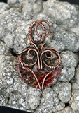 This unique pendant features a beautifully patterned Leopard Skin Jasper stone, nestled within a hand-sculpted copper owl design. The earthy tones and intricate patterns of the Jasper mirror the natural beauty of the wise owl, symbolizing wisdom and intuition. The copper detailing enhances the organic feel of the piece, making it a charming and meaningful accessory for nature lovers or those drawn to mystical symbolism.