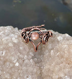 This enchanting ring features a luminous Peach Moonstone, wrapped in handwoven copper wire that enhances the stone's warm, soft glow. The adjustable design ensures a comfortable fit, while the earthy copper beautifully complements the Moonstone’s natural shimmer. Perfect for those who love mystical stones and handcrafted jewelry, this ring adds a touch of elegance and warmth to any ensemble.