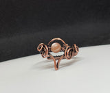 This enchanting ring features a luminous Peach Moonstone, wrapped in handwoven copper wire that enhances the stone's warm, soft glow. The adjustable design ensures a comfortable fit, while the earthy copper beautifully complements the Moonstone’s natural shimmer. Perfect for those who love mystical stones and handcrafted jewelry, this ring adds a touch of elegance and warmth to any ensemble.