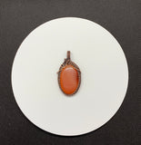 Striking striped natural salmon colored Agate Pendant wrapped in handwoven copper.