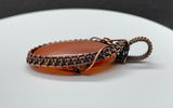 Striking striped natural salmon colored Agate Pendant wrapped in handwoven copper.