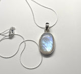 Shimmering iridescent Rainbow Moonstone Pendant is Sterling Silver on a 20" Sterling Silver chain. 