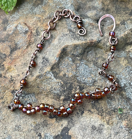 Delicate Adjustable Copper Bracelet with Glass Bead Wave Design. 