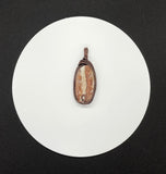 Natural Agate Pendant with flowing rivers of white and pink inside, wrapped in handwoven copper. 