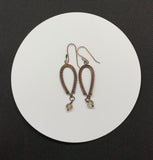 Handwoven Copper inverted teardrop earrings with clear crystal dangles on the end with hand made ear wires.