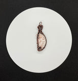 Soft Pink Natrolite Pendant in Wire Wrapped Copper. 