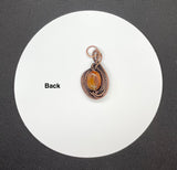 Two Tone Orange Agate Pendant in layers of wire wrapped copper. 