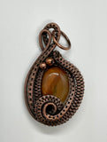 Two Tone Orange Agate Pendant in layers of wire wrapped copper. 