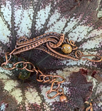 Woven Copper surrounds this Bronzite bead in this one of a kind handmade adjustable bracelet.