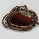 wire wrapped brown striped agate pendant in copper