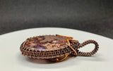 Gorgeous Pink and Purple Agate wrapped in Hand woven copper. A truly unique piece!