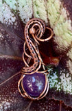 Square Copper wire flows around and captures this round light purple Amethyst Cabochon in this beautiful pendant.