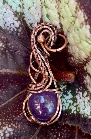 Square Copper wire flows around and captures this round light purple Amethyst Cabochon in this beautiful pendant.