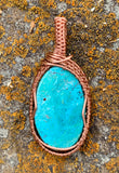 Add a stunning pop of color to your wardrobe with this beautiful turquoise blue Chrysocolla Cabochon wrapped in handwoven copper. 