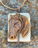 Carved Succor Creek Jasper Horse Head Necklace in Copper with adjustable leather cord.