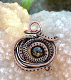 This Pendant has layers of handwoven copper copper surrounding a beautiful Golden Green Tourmaline.  