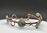 This adjustable Copper Bracelet features wire wrapped Copper, Copper Swirls and Green Line Jaspers.