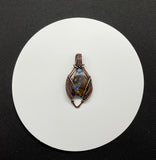 Beautiful Boulder Opal Pendant in wire wrapped copper with an Aquamarine accent. 