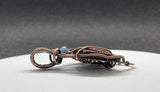 Beautiful Boulder Opal Pendant in wire wrapped copper with an Aquamarine accent. 