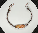 Sunny orange Striped Agate bracelet with copper weaves and swirls. Adjustable. 