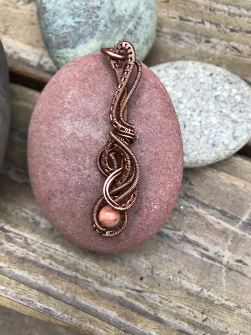 Handmade woven copper pendant with a crazy lace bead