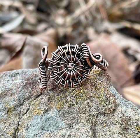 Wire Wrapped Copper Ring with a Czech Glass Circle inside. Adjustable from size 7-9. 