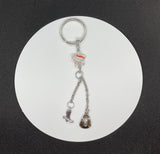 This handmade keychain features a glass star and a dangling cowboy hat and boot.