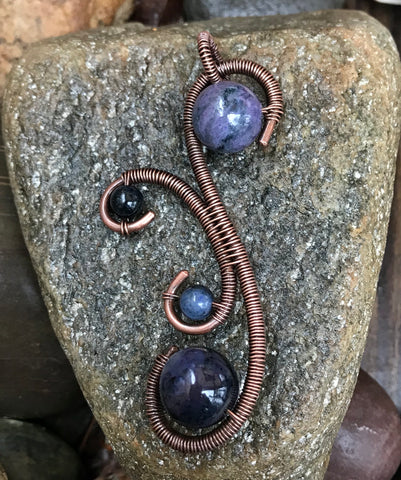 Heavy gauge copper pendant with violet-blue to a darker blue Dumortierite beads.