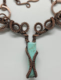 Handwoven Copper weaves capture a Chrysocolla spike then curl and swirl around each other in this one of a kind necklace. 