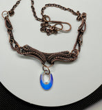 Wire Wrapped Copper Necklace with layers of Copper weaves on multiple components with an iridescent Swarovski Crystal Dangle. 