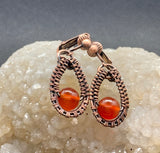 Handwoven Copper combined with bright Carnelian beads to make a beautiful pair of clip on earrings.
