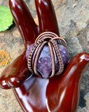 Add a touch of charm and calming energy to your jewelry collection with this chunky Lepidolite heart pendant. The soft, shimmering purple hues of the Lepidolite are beautifully accented by intricate handwoven copper wire. 