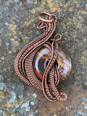 Intricately wire wrapped Jasper Donut Pendant with layers of hand woven Copper Weaves and Coils. 