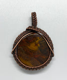Brown, Red and Gold Tiger Iron Pendant wrapped in handwoven copper. 