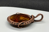 Brown, Red and Gold Tiger Iron Pendant wrapped in handwoven copper. 