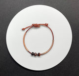 Adjustable Leather Bracelet with Copper Tubes and Red Tiger Eye. 
