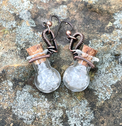 Wire Wrapped Copper and Glass Bottle Earrings filled with Clear and Light Smoky Quartz Tumbles on Niobium Ear Wires. 