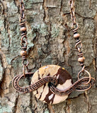 Brown Zebra Jasper Donut wrapped in handwoven copper to create this unique necklace with copper bead accents.
