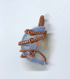 This Opalite Moon Pendant wrapped in Handwoven Copper is a beautifully crafted pendant that marries the mysticism of the moon with the earthy warmth of copper. Its celestial symbolism, glowing Opalite stone, and intricate copper weaving make it a unique and enchanting accessory, perfect for anyone who appreciates handmade, nature-inspired jewelry.