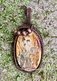 Colorful Graveyard Point Plume Agate Pendant wrapped in handwoven copper with copper accent beads.