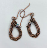 Handwoven Copper Earrings with Iridescent Glass Bead Accents.