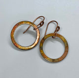 Colorful flame painted copper earrings on handmade copper ear wires.