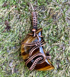 Lovely Striped Golden Tiger Eye Moon Cabochon wrapped in handwoven Copper and then given a patina to match the colors in the stone.